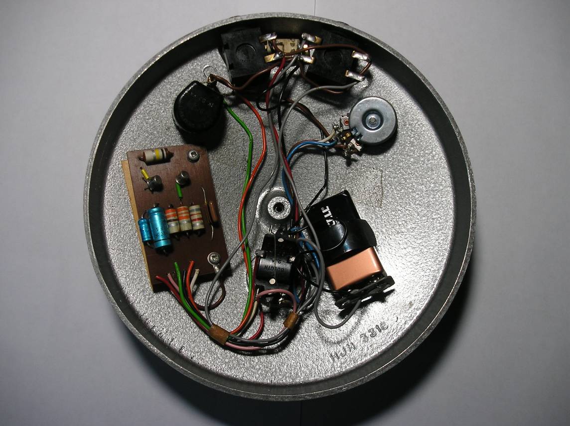 Inside a Dallas-Arbiter Fuzz Face showing circuit board, pots, switch and battery