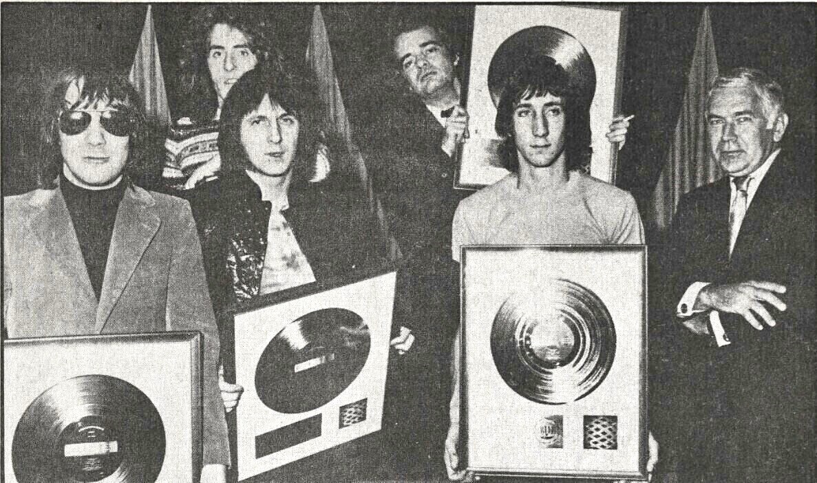The Who receiving a gold record for the Tommy album