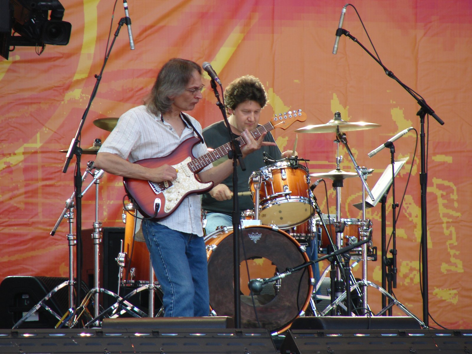 Sonny Landreth performing with his trio on an outdoor festival stage