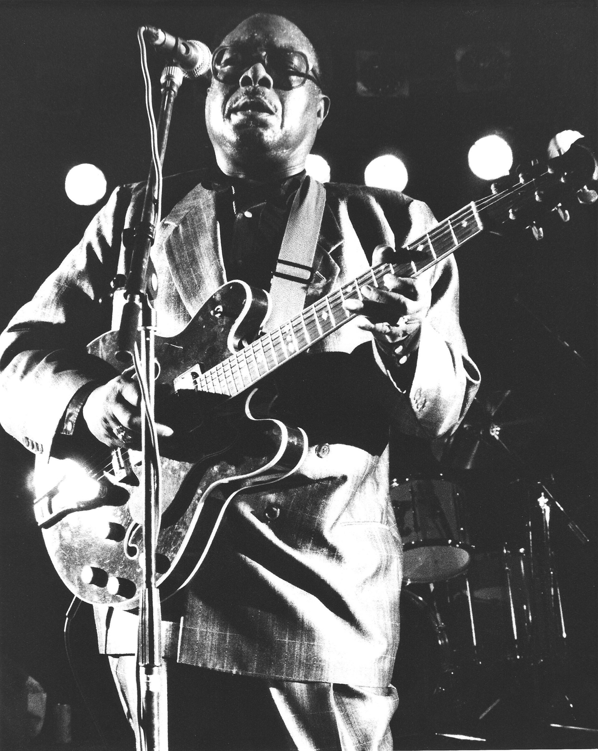Jimmy Rogers singing and playing a hollow-body electric guitar on stage in 1991