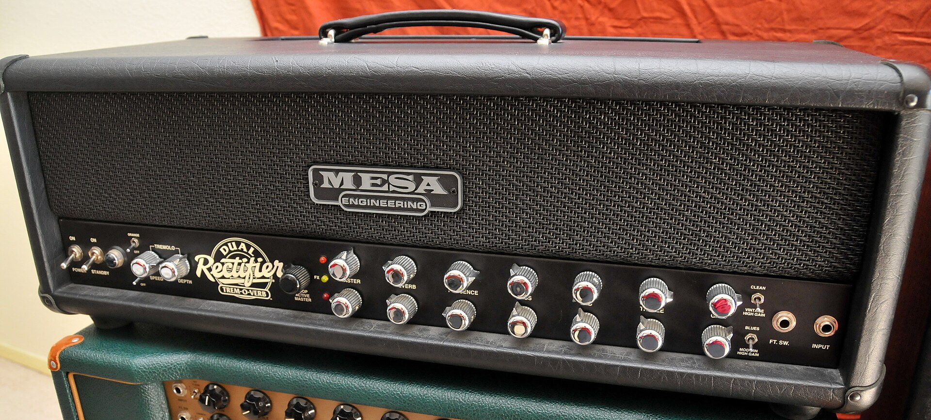 A Mesa/Boogie Dual Rectifier Tremoverb head. With the Drive down and the Level up, a Tube Screamer is a common way to tighten amps like this. Illustrative.