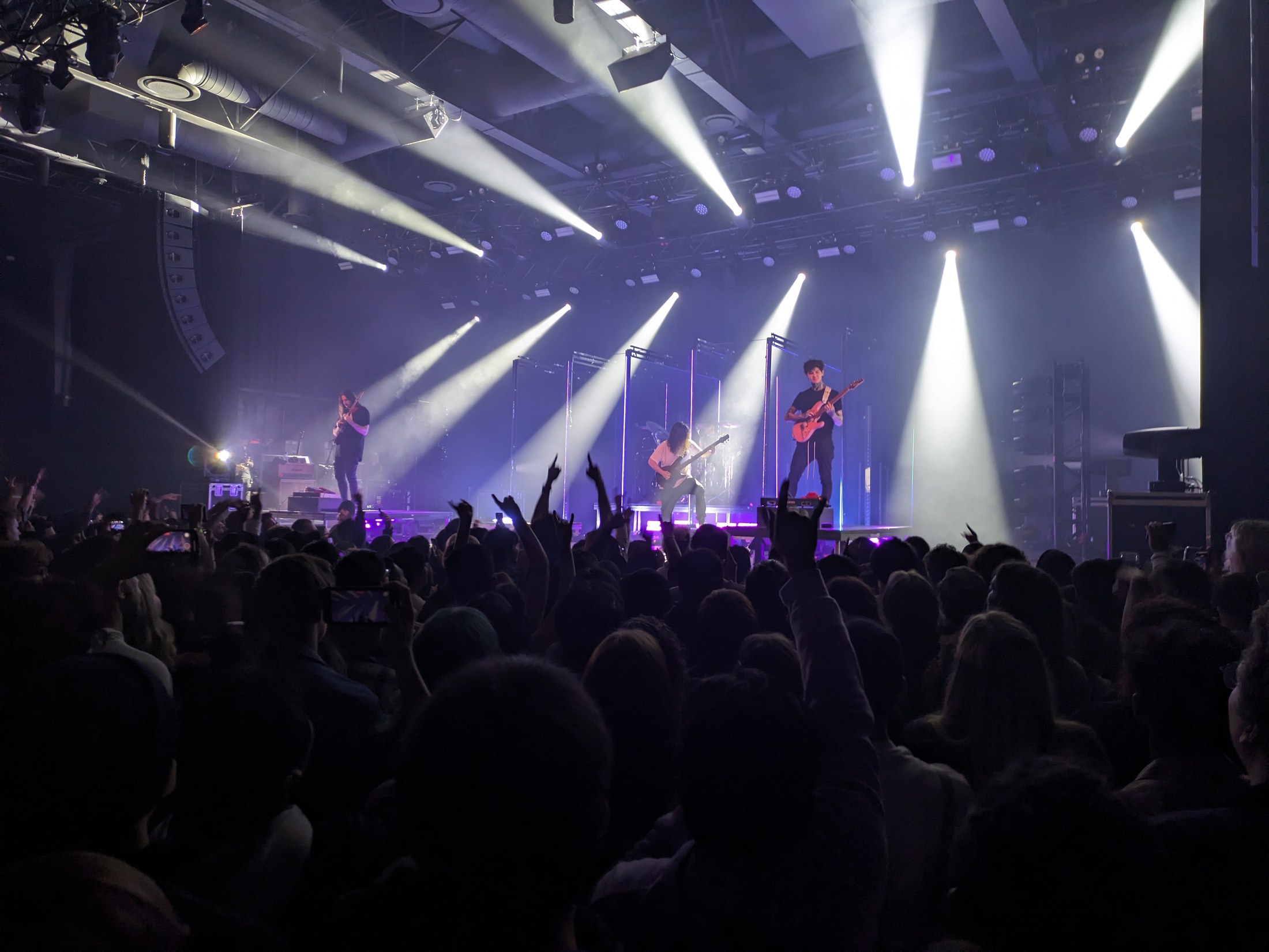 Polyphia performing onstage at History in Toronto with both guitarists visible under stage lights