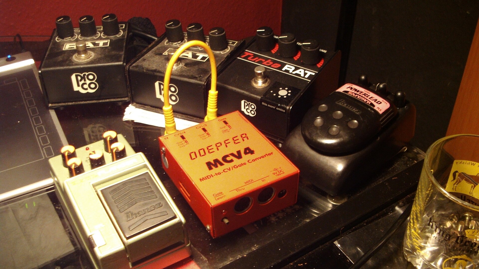Two ProCo RAT pedals and a TurboRAT on a studio floor with other effects units