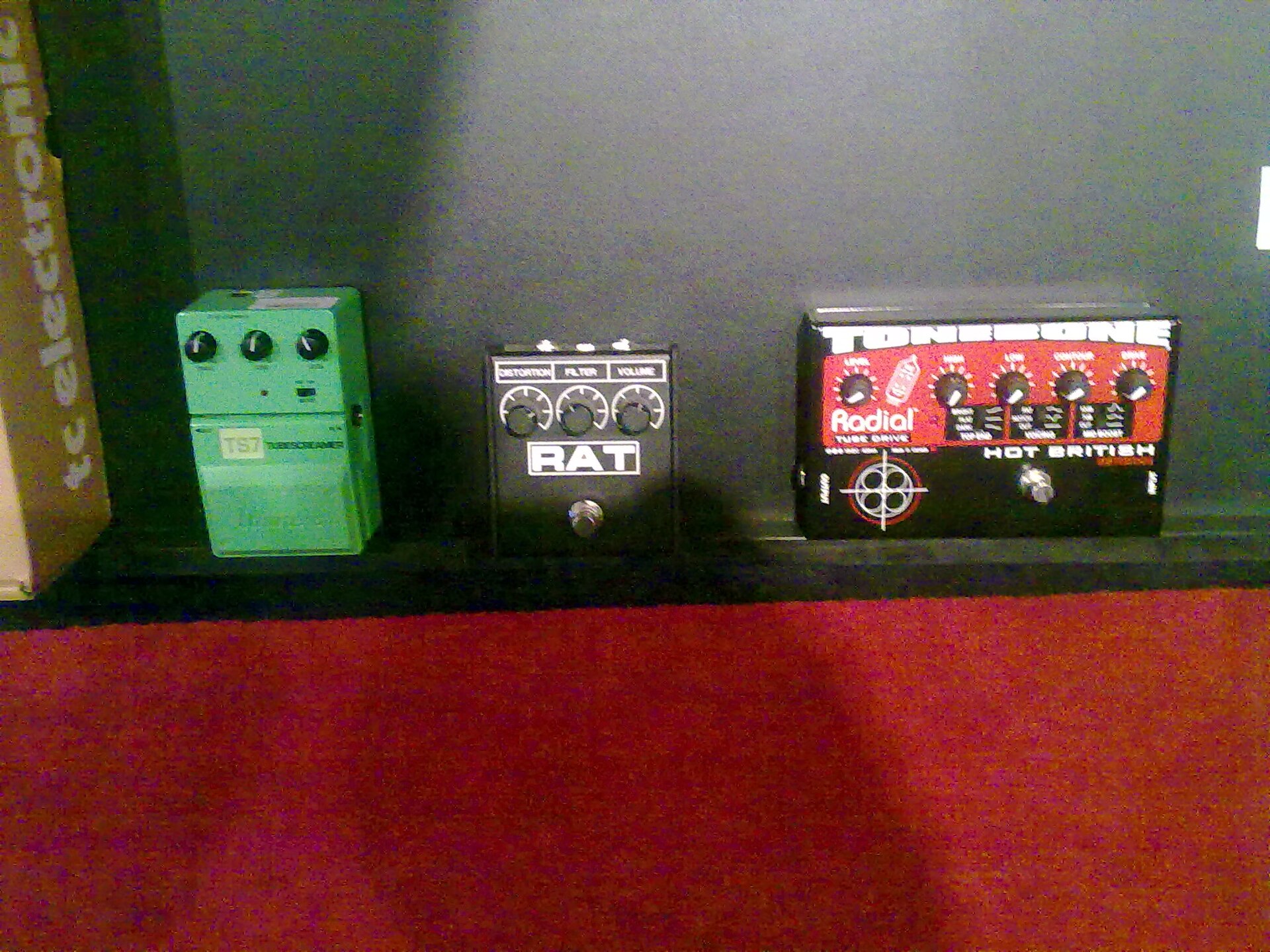 A ProCo RAT between an Ibanez TS7 and a Radial Tonebone Hot British pedal on a floor