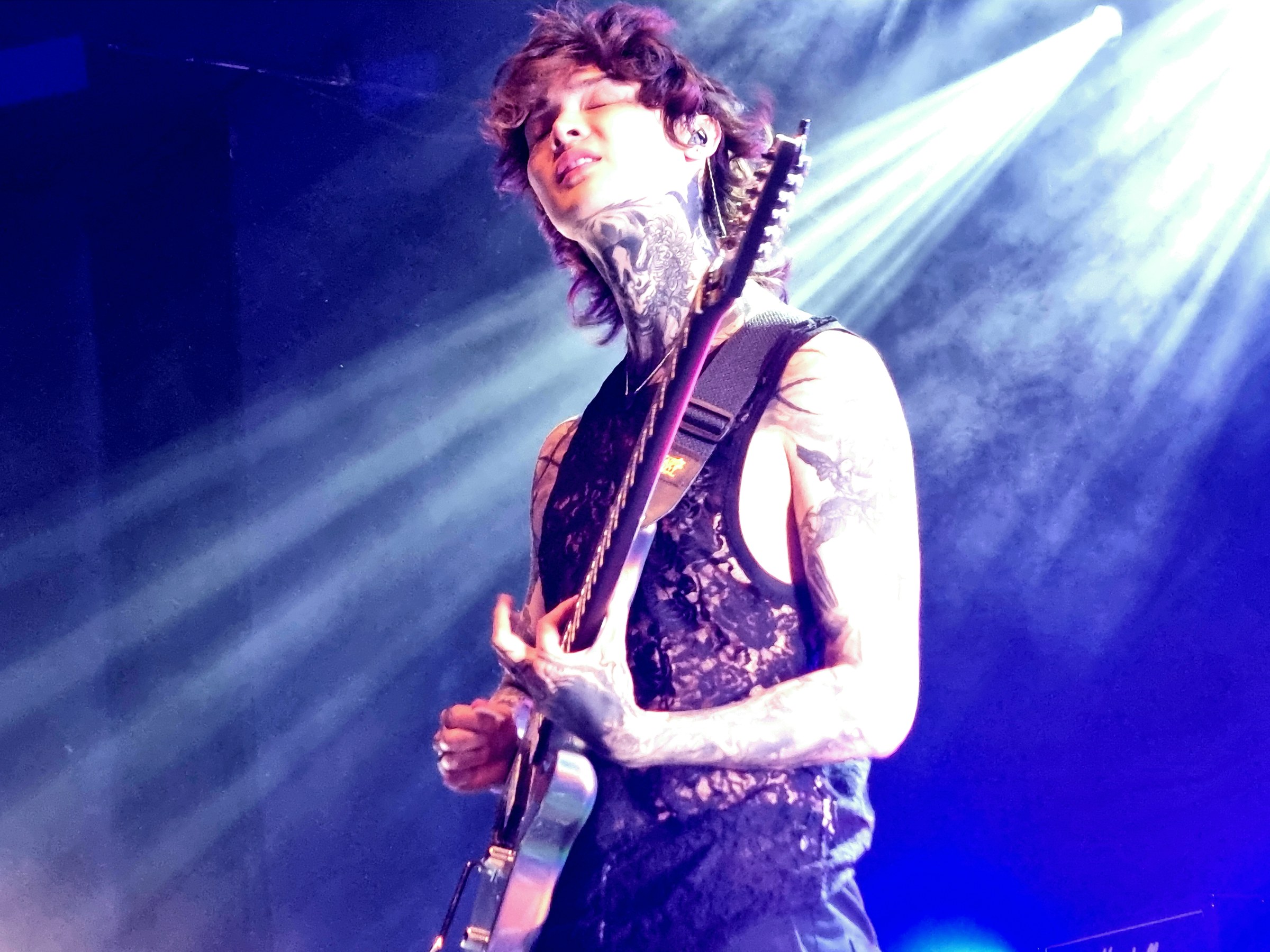 Tim Henson of Polyphia playing guitar onstage at Shepherd's Bush Empire in London