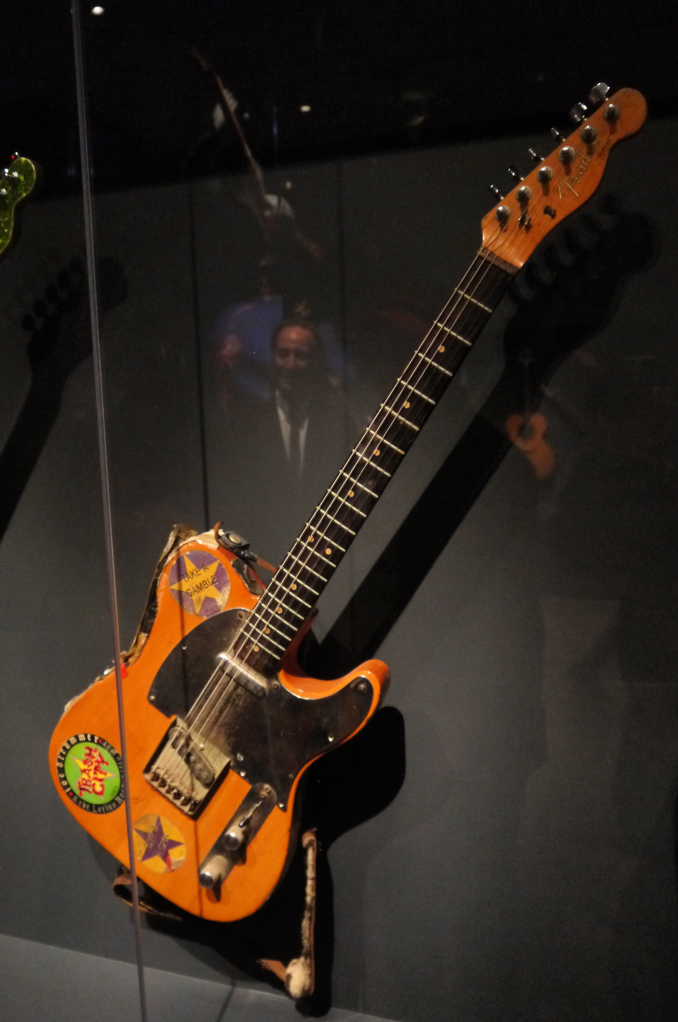 Joe Strummer's heavily worn 1966 Telecaster displayed in a museum case