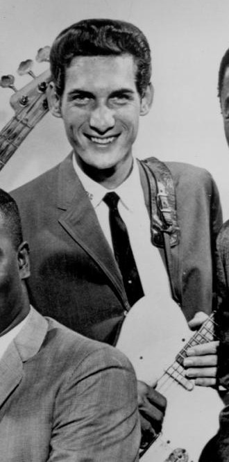 Steve Cropper smiling in a 1967 black-and-white publicity photo, holding a guitar