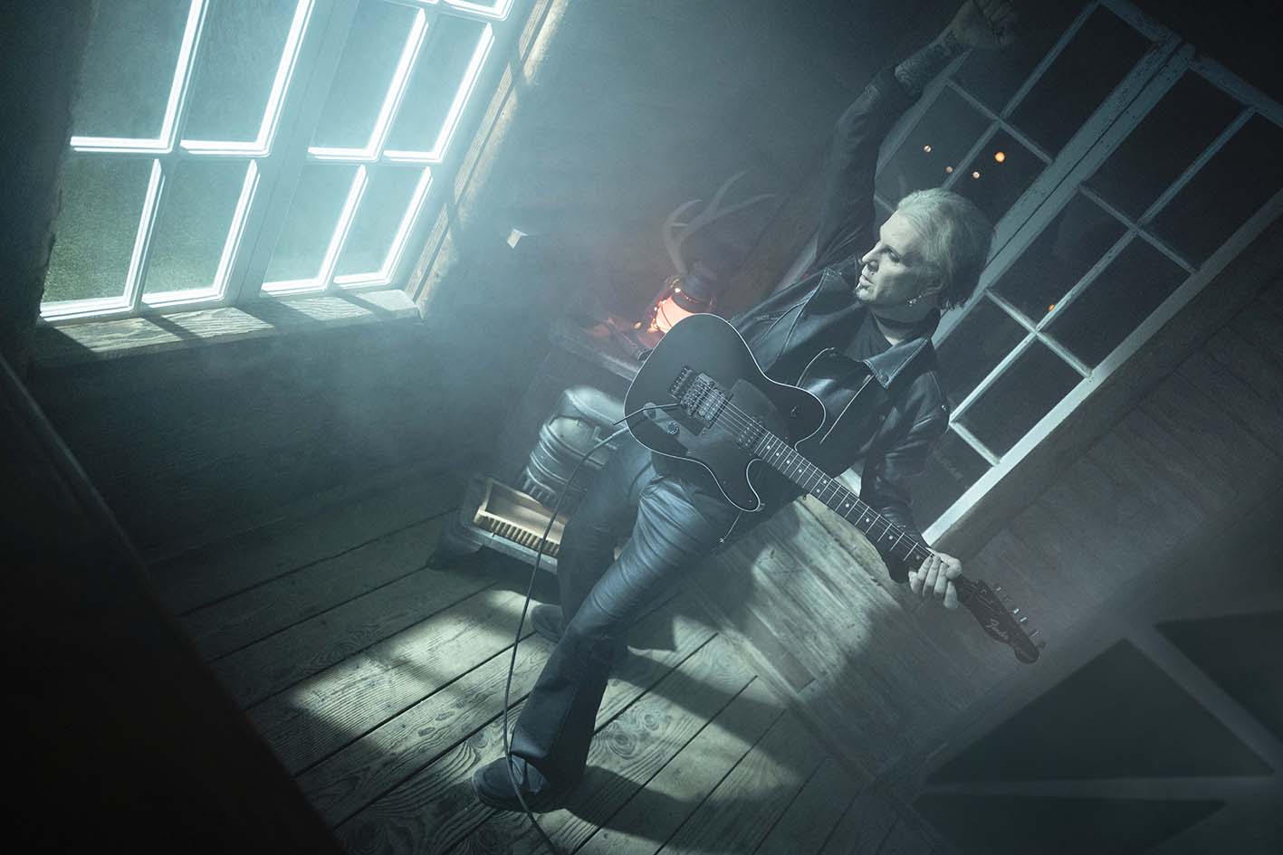 John 5 playing the black Fender Custom Shop John 5 Phantom Telecaster in a smoky, window-lit wooden room
