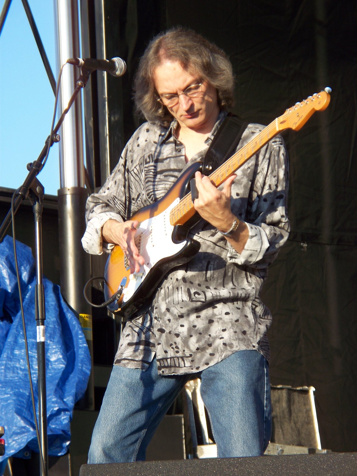 Sonny Landreth fretting notes behind a slide on his little finger while playing a maple-neck Stratocaster