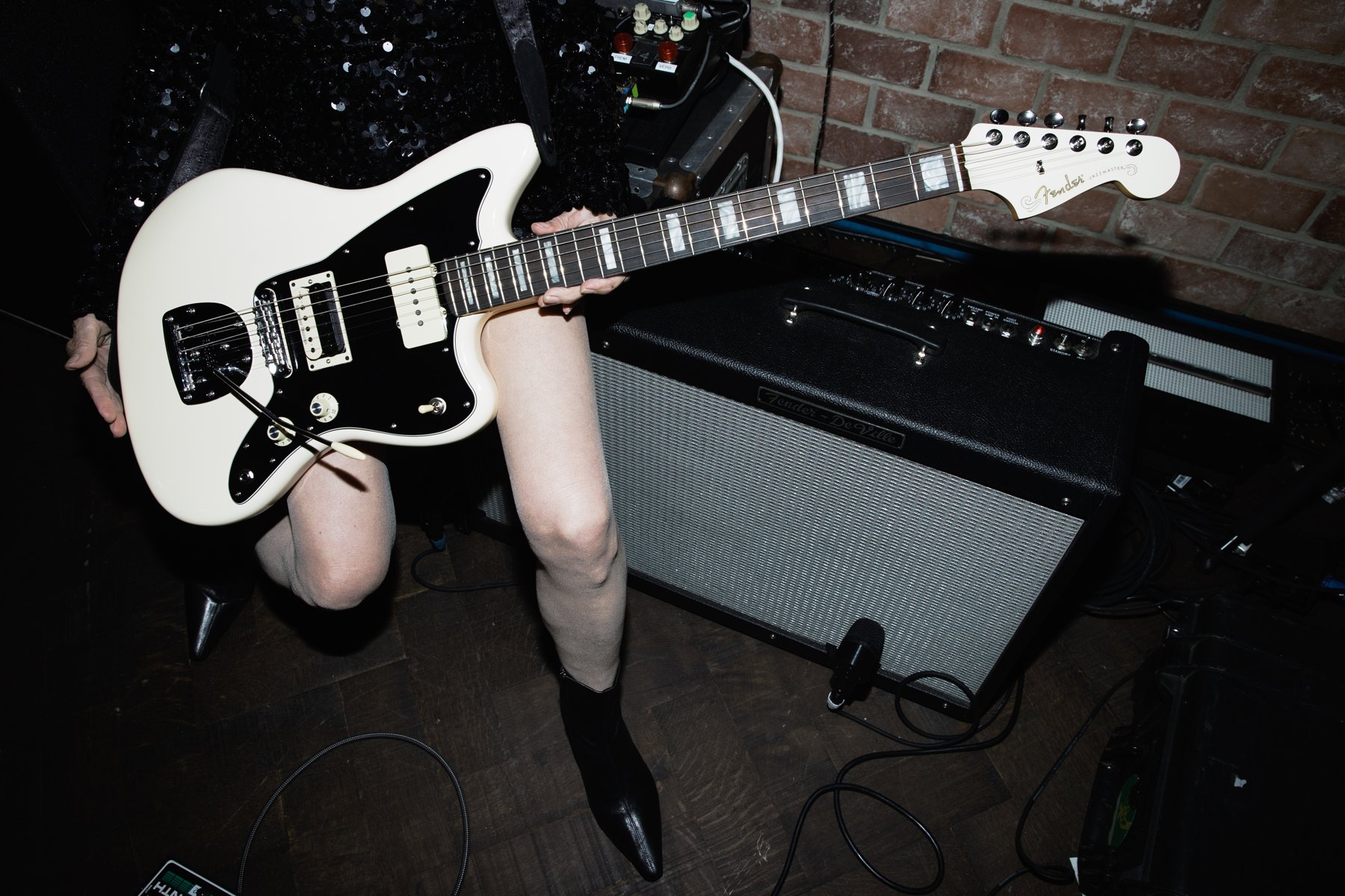 The Kim Gordon Jazzmaster plugged into an amp next to a pedalboard