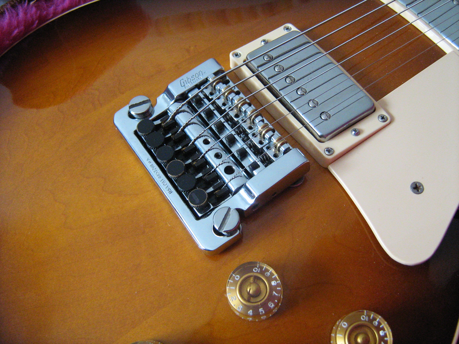 Chrome Kahler tremolo on a sunburst Les Paul next to the bridge pickup