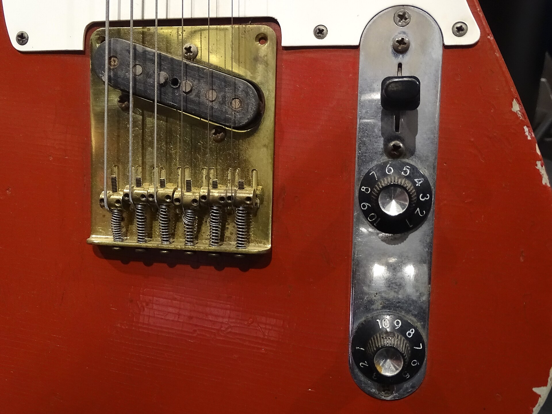 Close-up of the bridge pickup, control plate and knobs on Muddy Waters' red 1958 Fender Telecaster at the Rock & Roll Hall of Fame