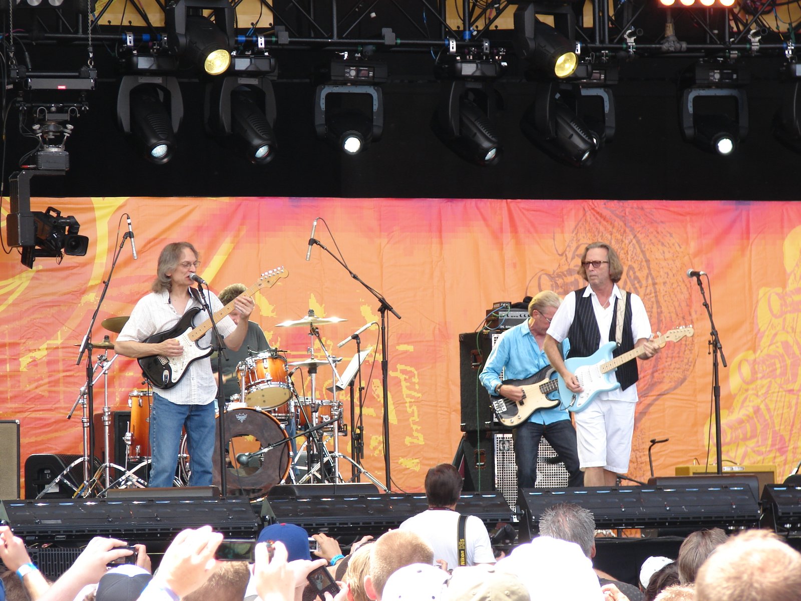 Sonny Landreth and Eric Clapton playing together on an outdoor festival stage