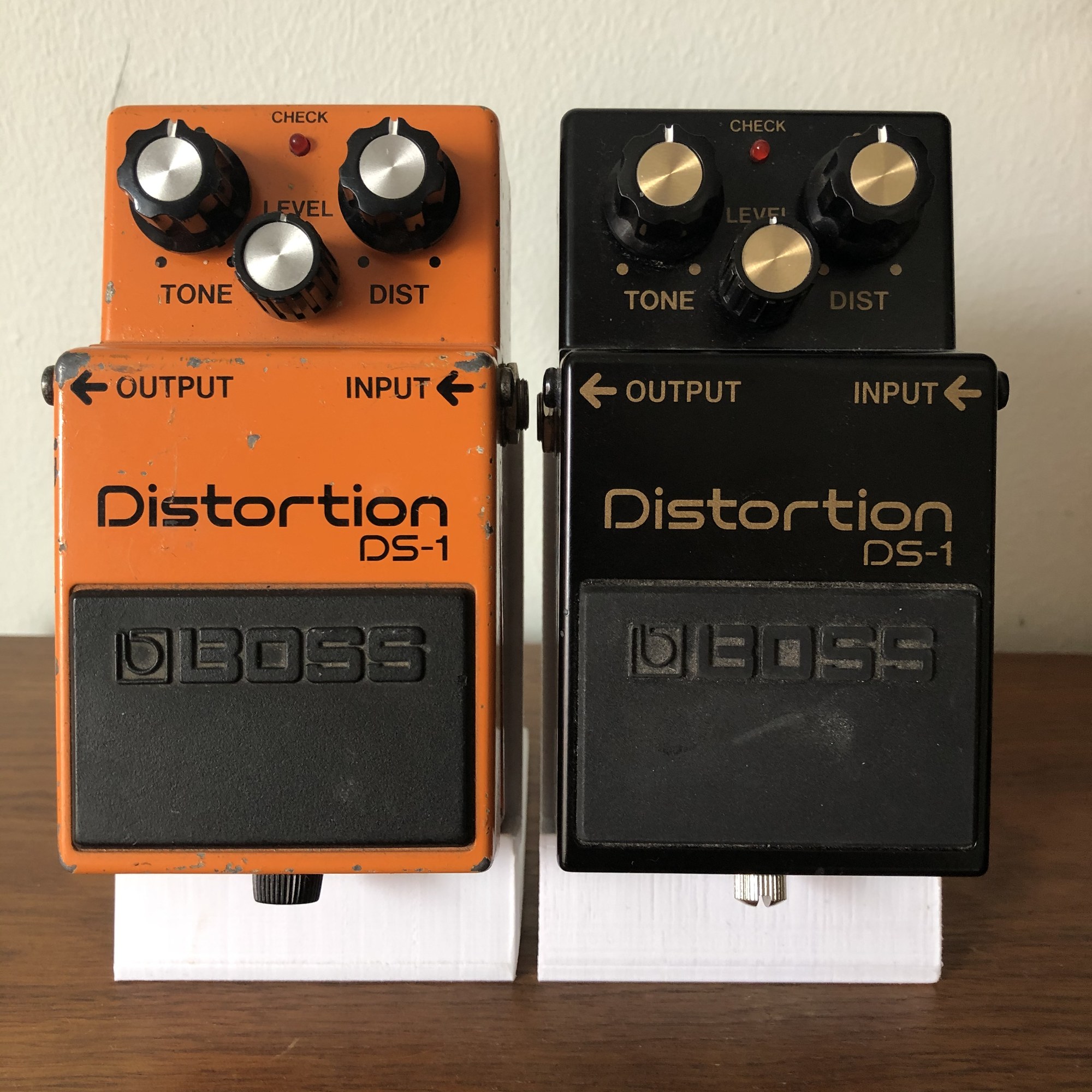Classic orange Boss DS-1 next to the black DS-1-4A 40th-anniversary edition