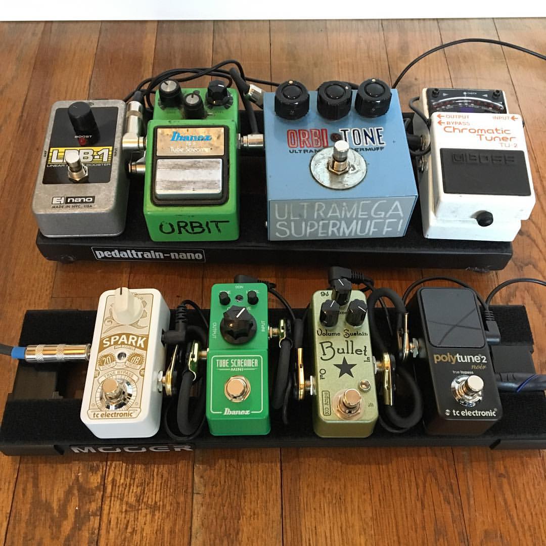 A real-world pedalboard with a TS9 Tube Screamer in the middle of the chain (top row), alongside a mini-pedal board.