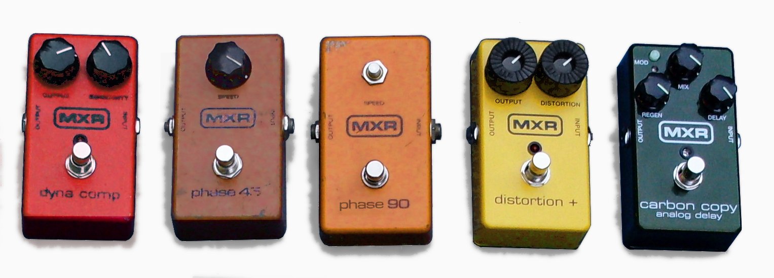 Row of five vintage MXR effects pedals in red, orange, yellow and green, with an orange Phase 90 in the middle