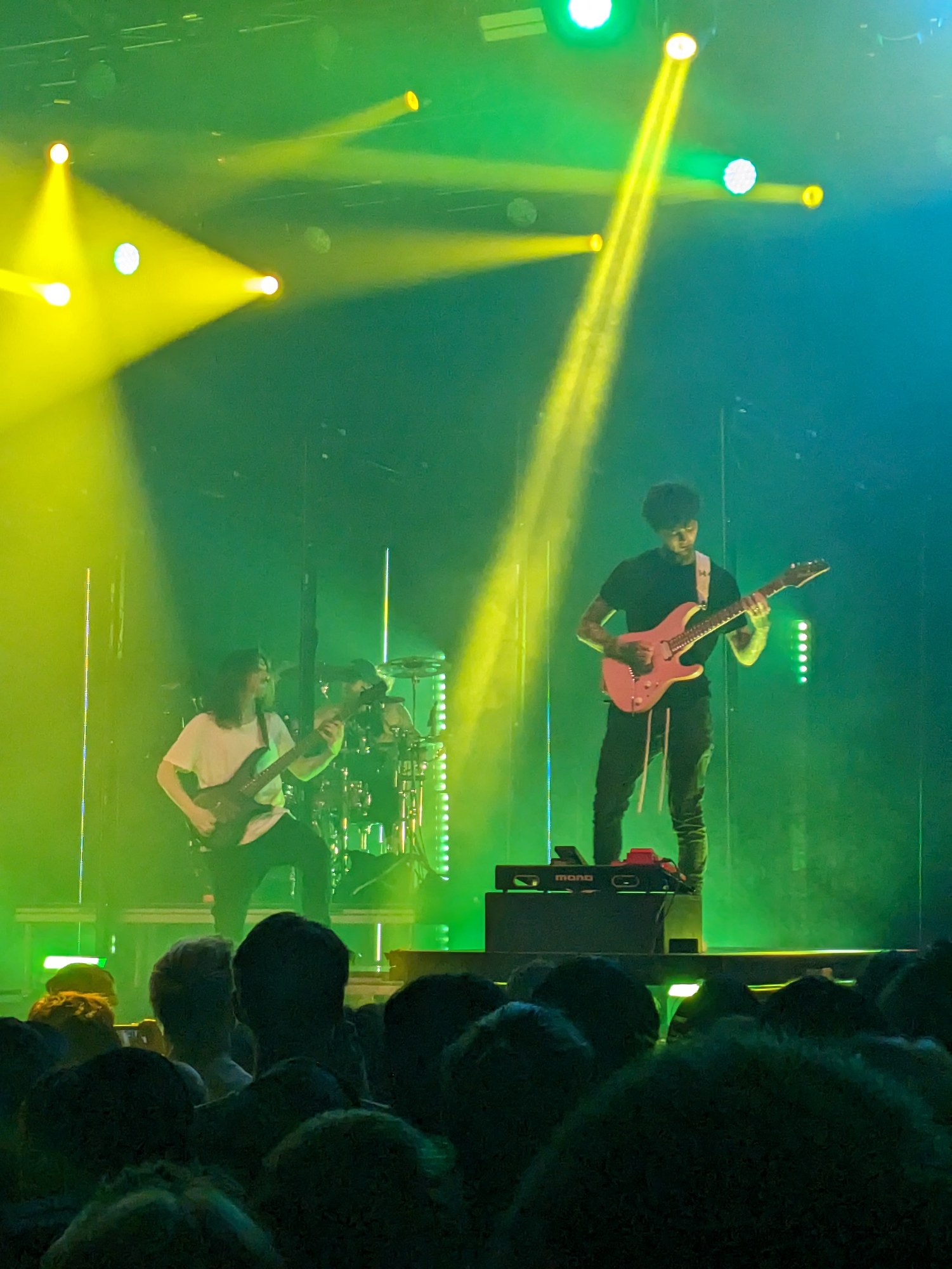 Close-up of Polyphia guitarists performing onstage in Toronto