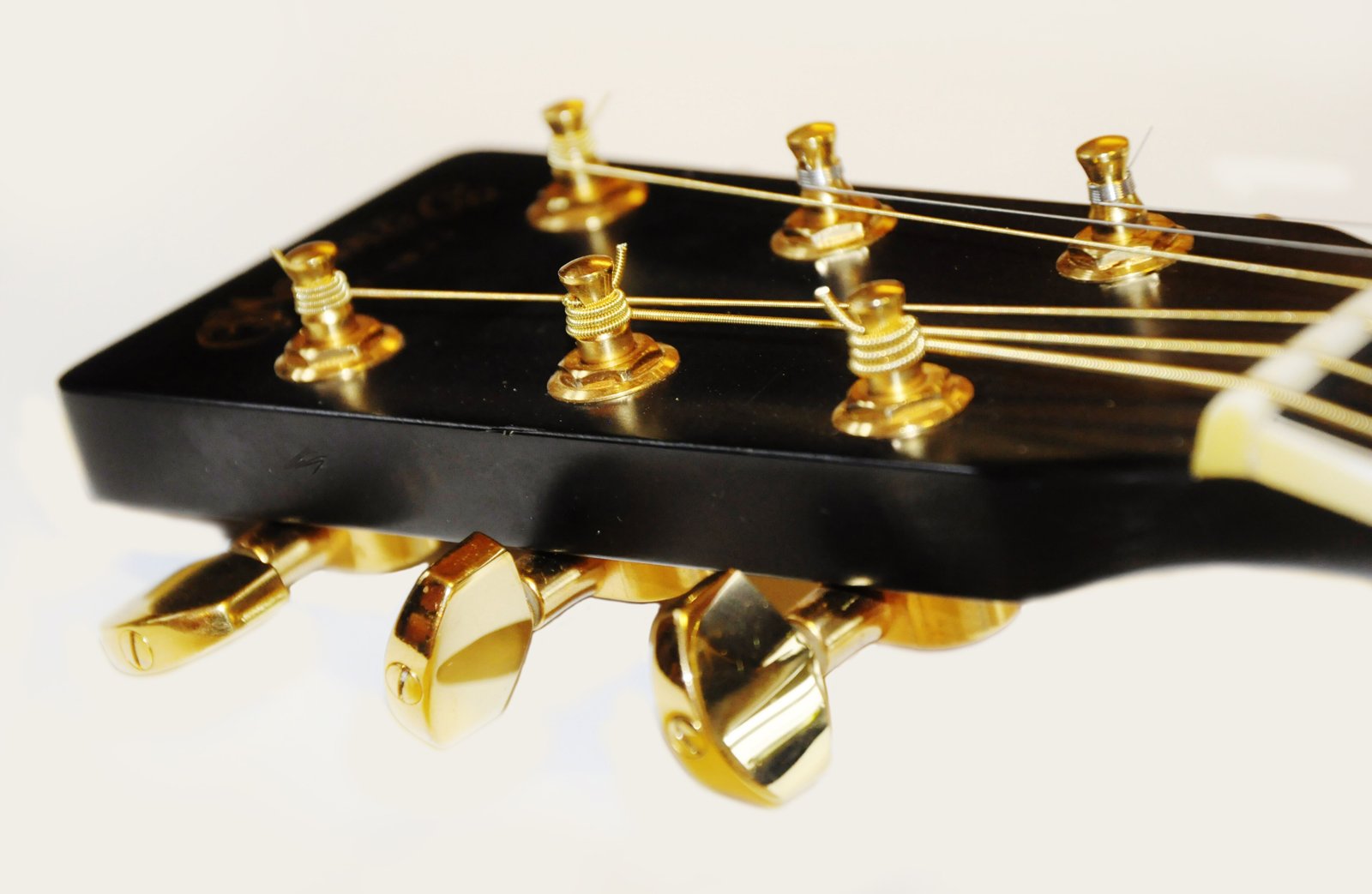 Tuning posts on a steel-string guitar. Neat wraps that wind downward help strings hold tune and avoid kinks that become weak points.