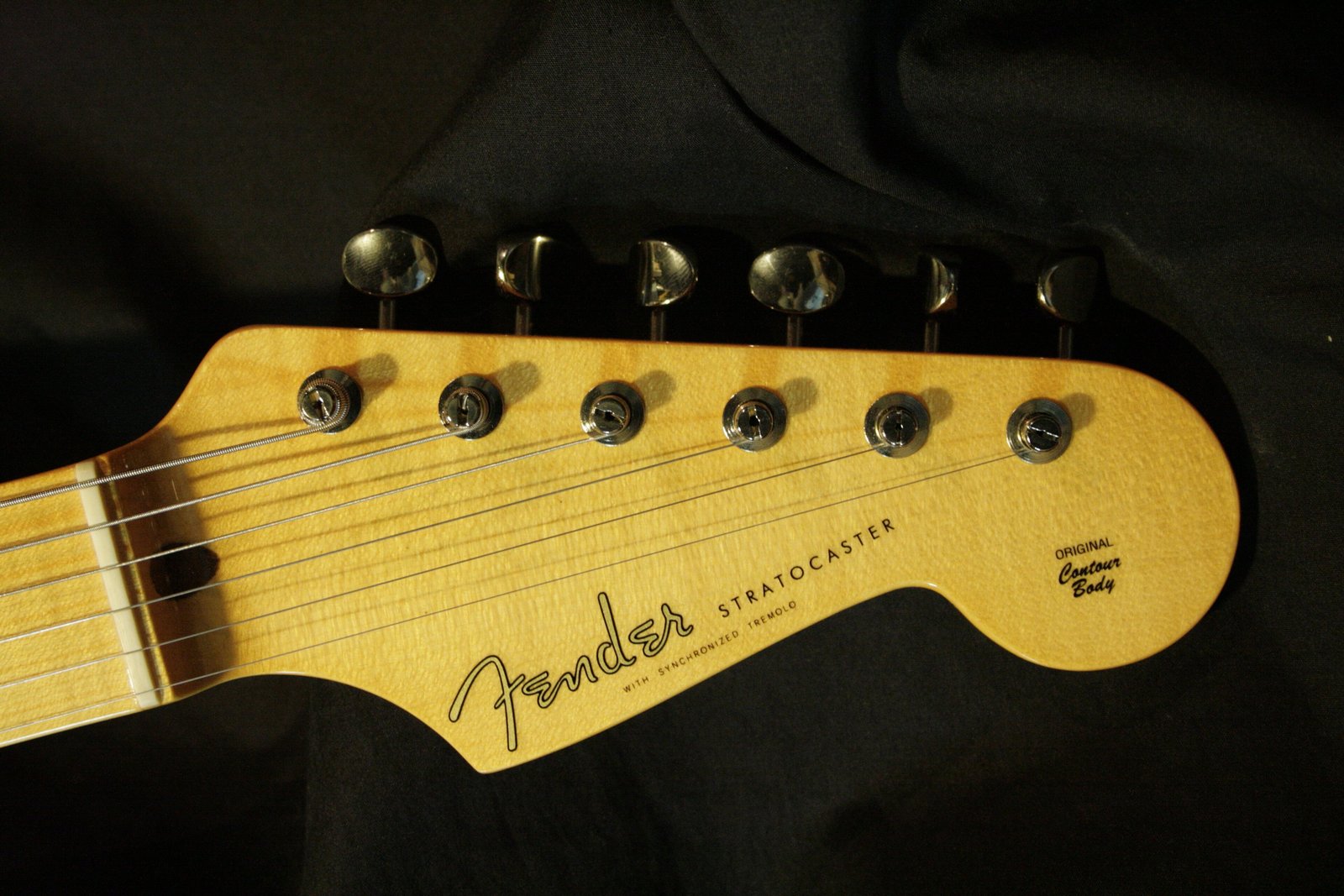 A Stratocaster headstock. Check the nut slots and tuning posts if strings keep breaking at this end of the guitar.