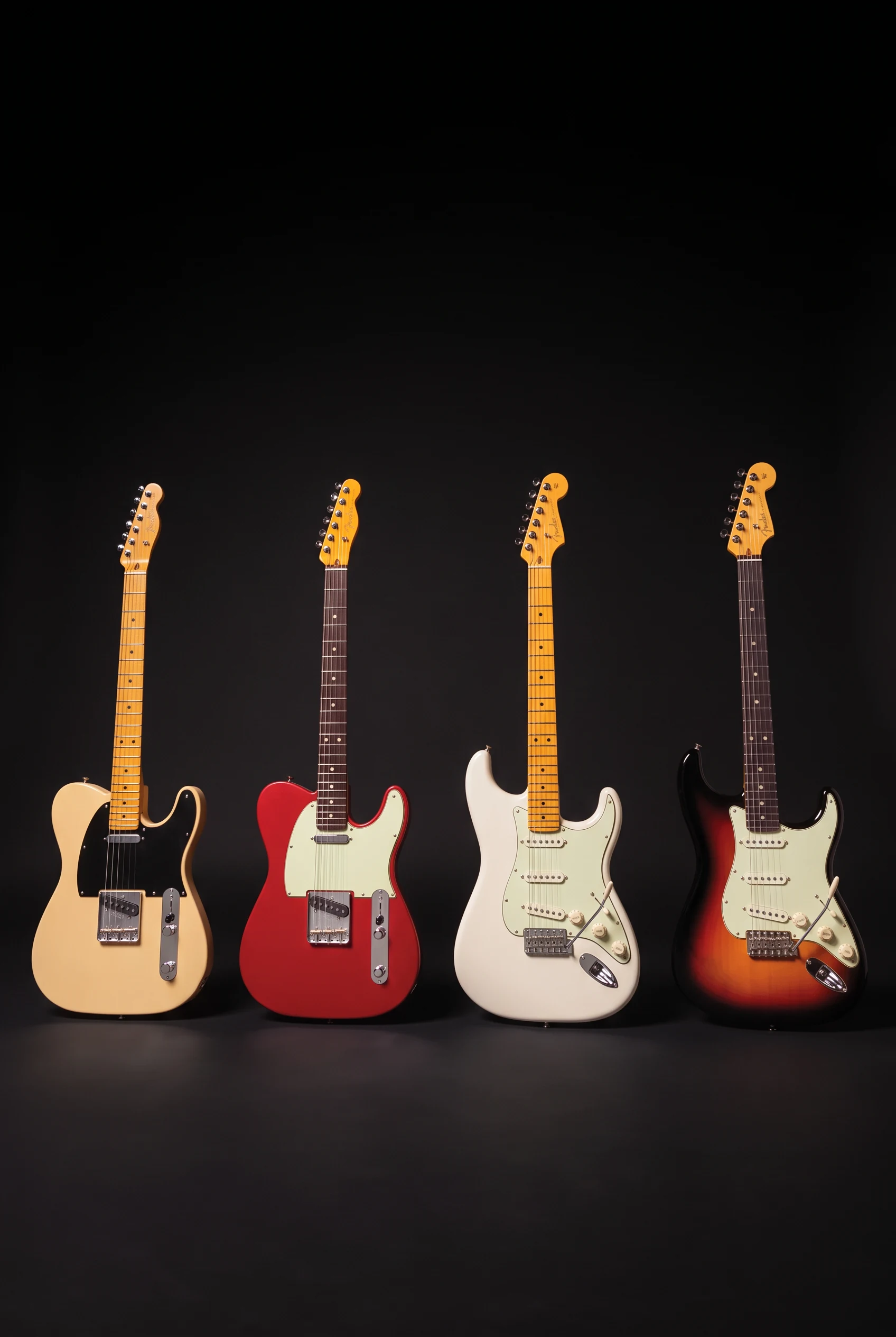 Four electric guitars — cream and red Telecaster-style models and white and sunburst Stratocaster-style models — against an edited black studio background; not confirmed Silent System models